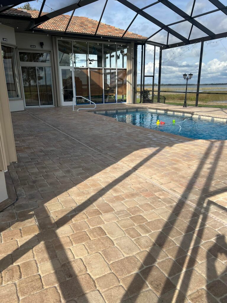 Paver Sealing in Lakeland 4 a swimming pool outside of a house. Paver sealing in Winter Haven
