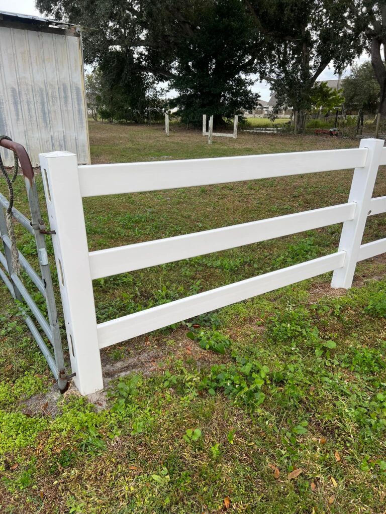 Fence Cleaning in Lakeland 4 a white fence in a field. Professional fence cleaning in Winter Haven.