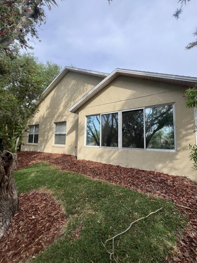 Winter Haven 13 a house with trees around it. Freshly pressure washed windows by W3 Pressure Cleaning