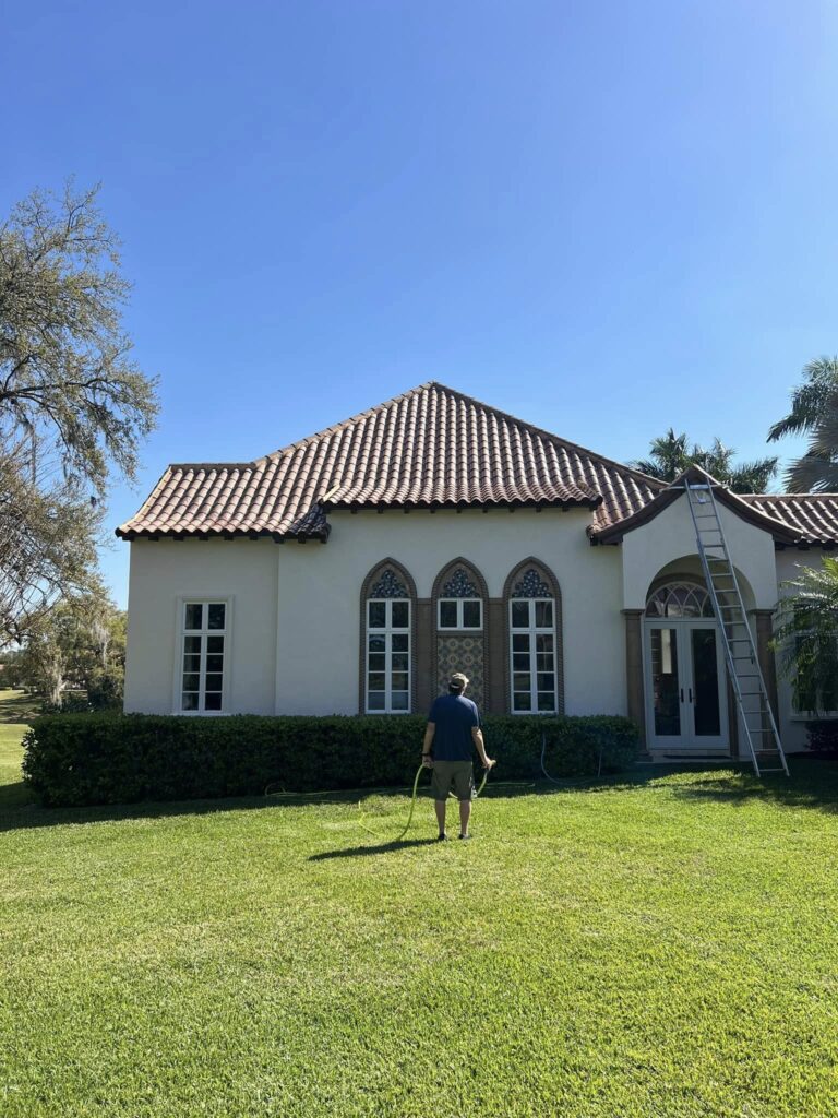 House Washing 5 a man standing in front of a house. The best house washing in Central Florida
