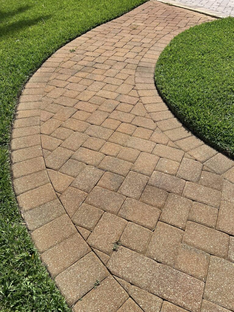 Paver Sealing In Auburndale 5 a brick path with grass around it. Paver sealing in Auburndale