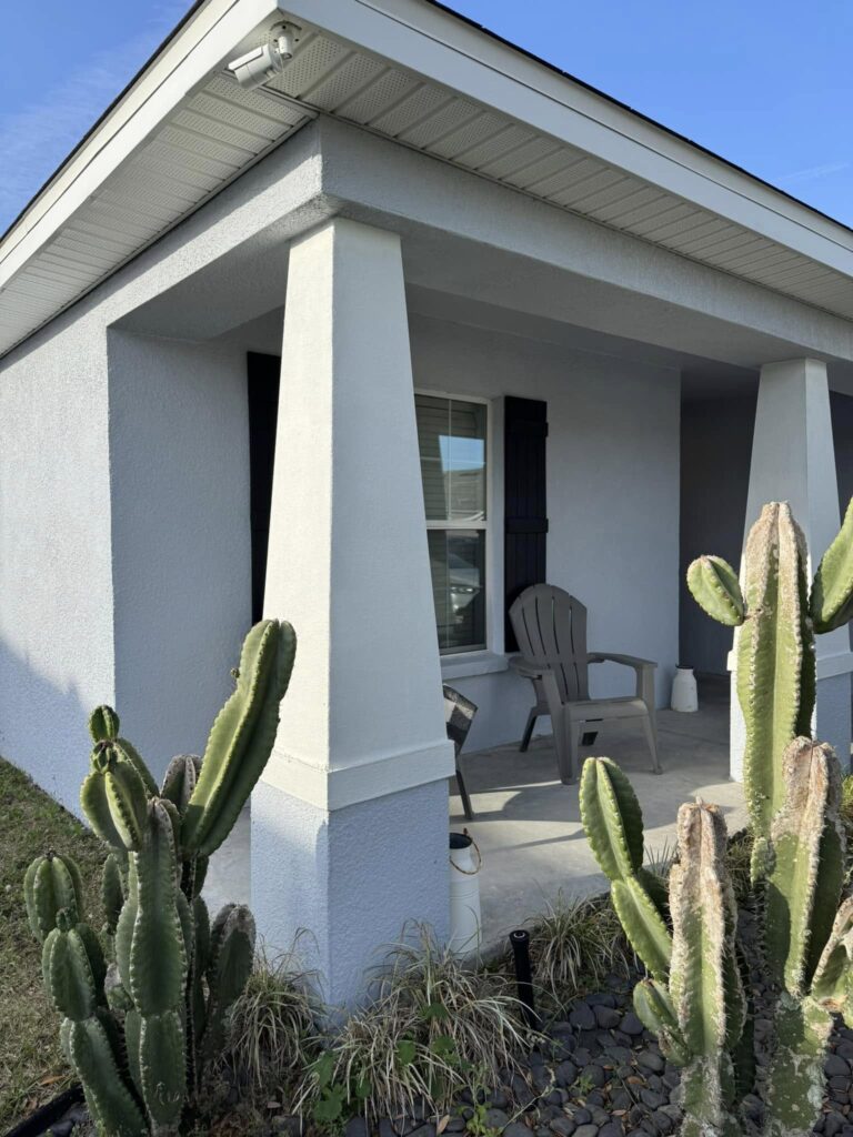 House Washing 4 a house with cactus plants. Stucco has been freshly power washed. Soft washing in Central Florida
